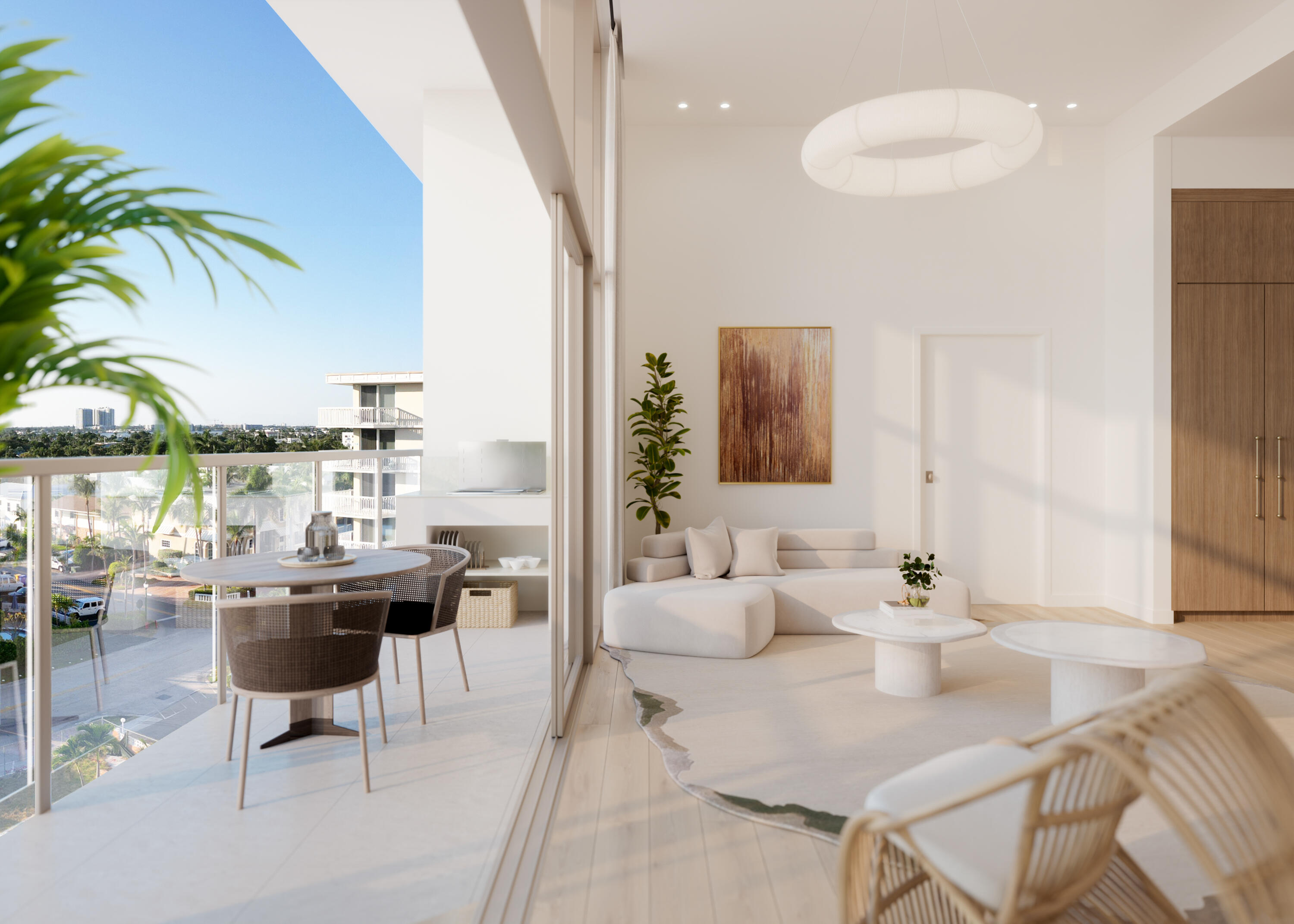 Contemporary living room with a white sectional and balcony dining area overlooking nearby buildings.