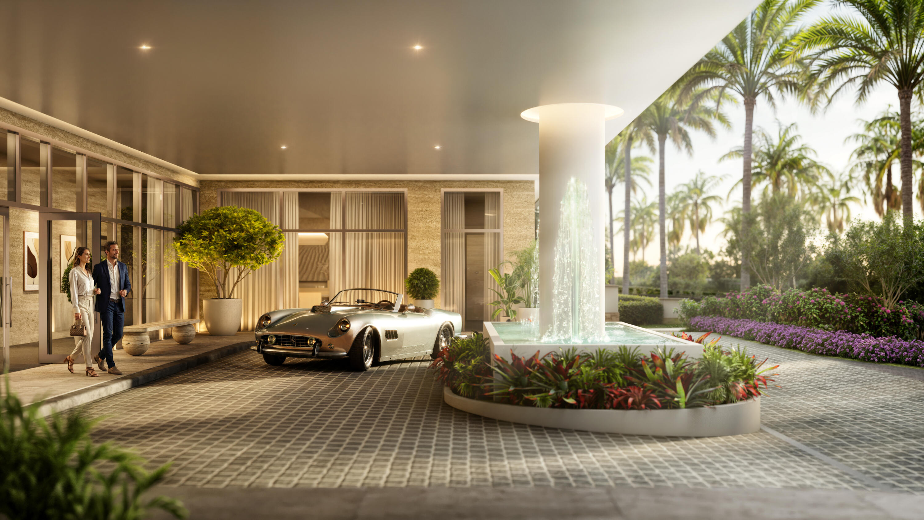 Luxury residence entrance with a tall fountain, tropical landscaping, and a covered drop-off area.