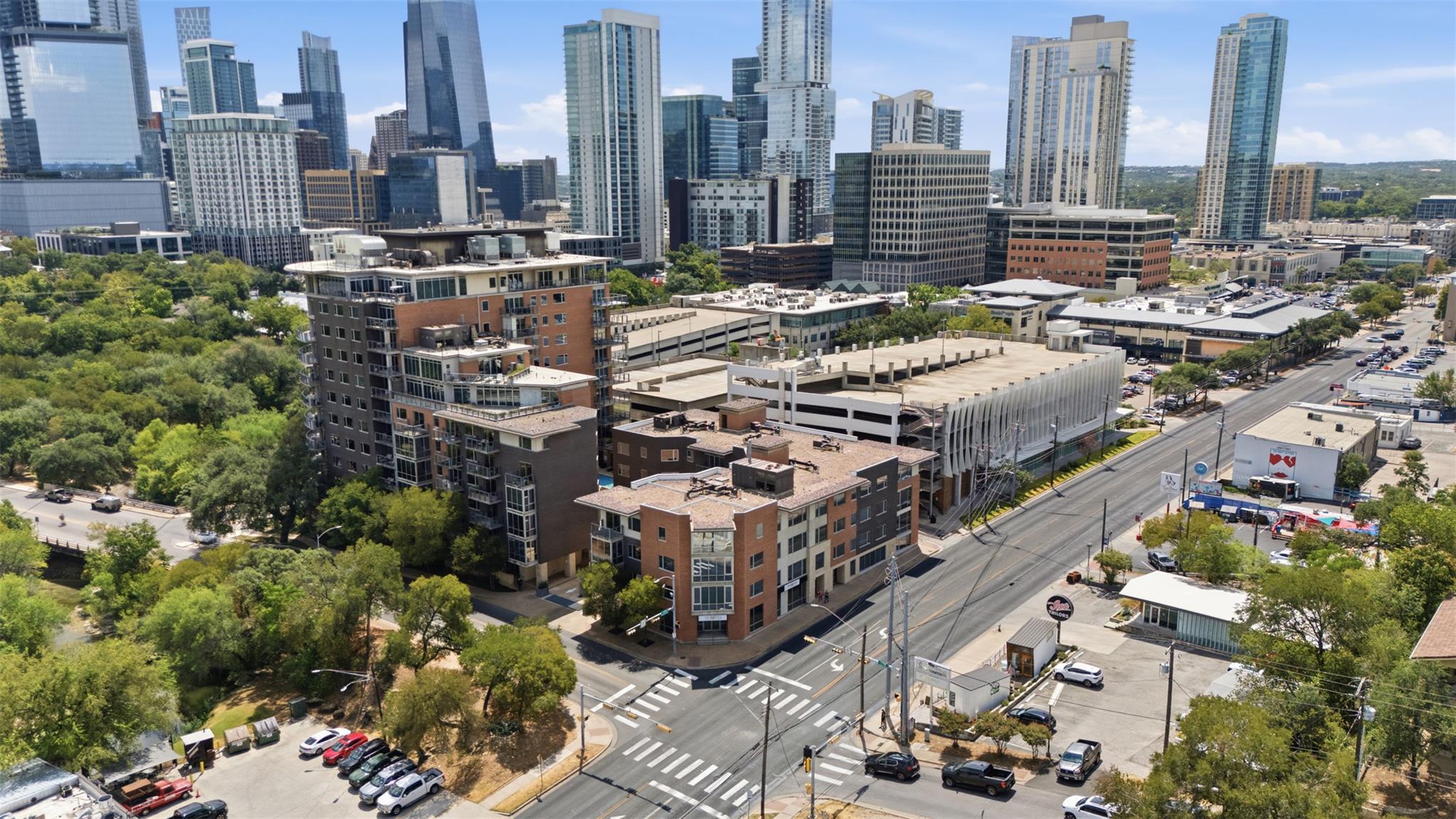 Aerial view of downtown Austin high-rises and a neighborhood intersection.