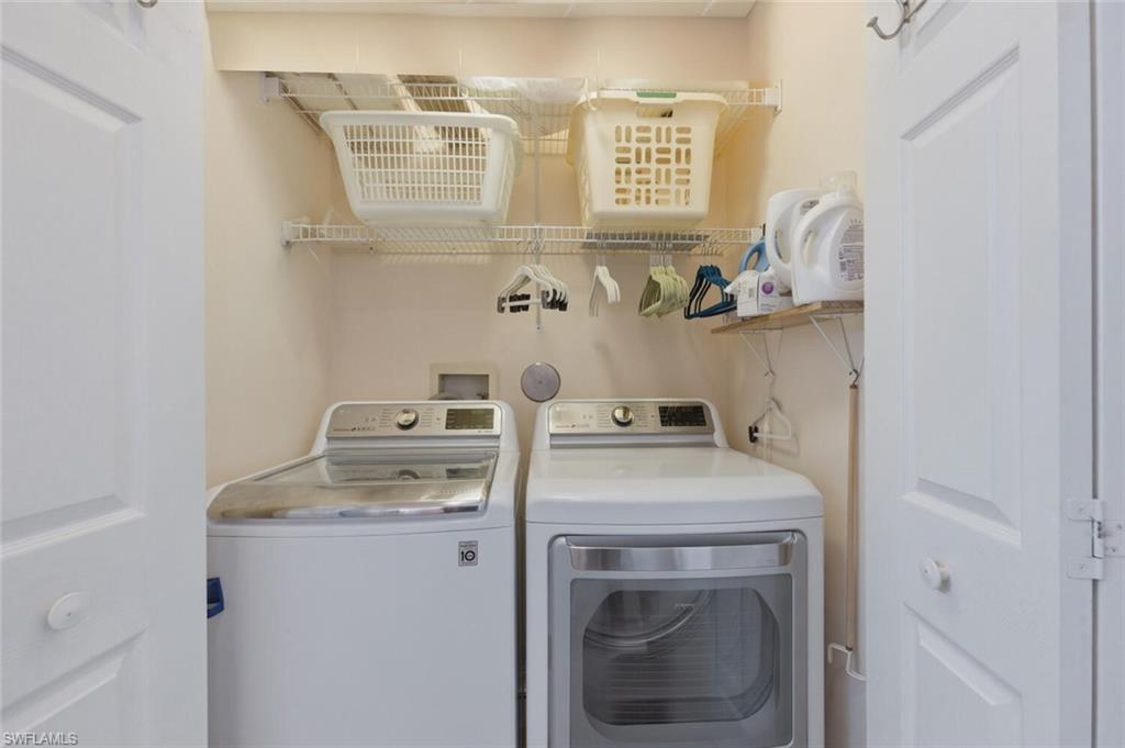 Laundry room with a top-loading washer, front-loading dryer and white wire shelving.