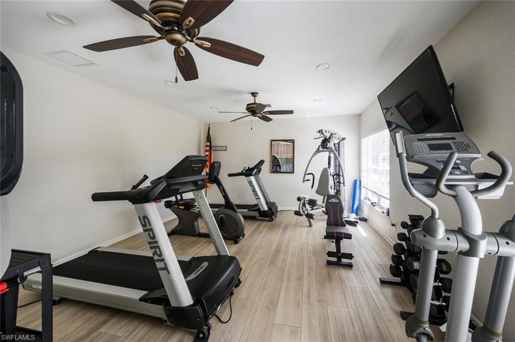 Home fitness room with treadmills, elliptical machines, and weight-training equipment.
