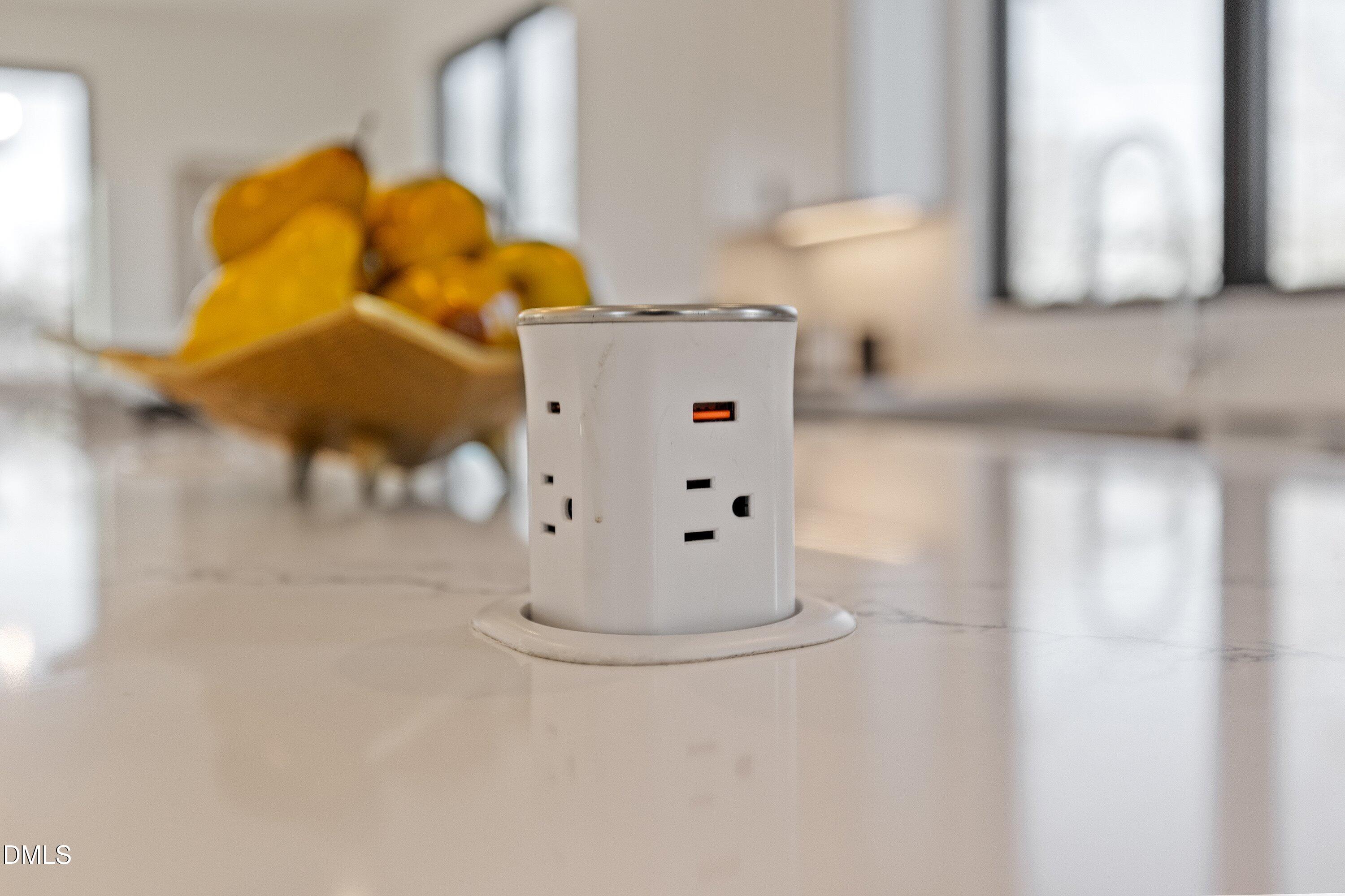 Pop-up kitchen countertop outlet with electrical sockets and a USB port