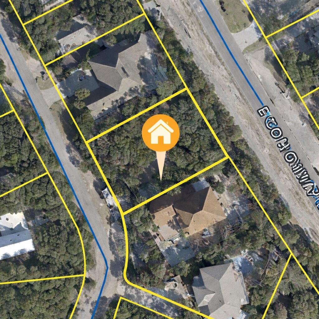 Aerial view of a wooded vacant lot outlined by parcel lines on a residential street.