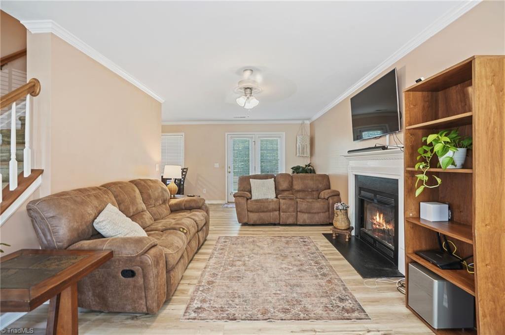 Living room with brown recliners, a fireplace, and a tall wooden shelving unit.
