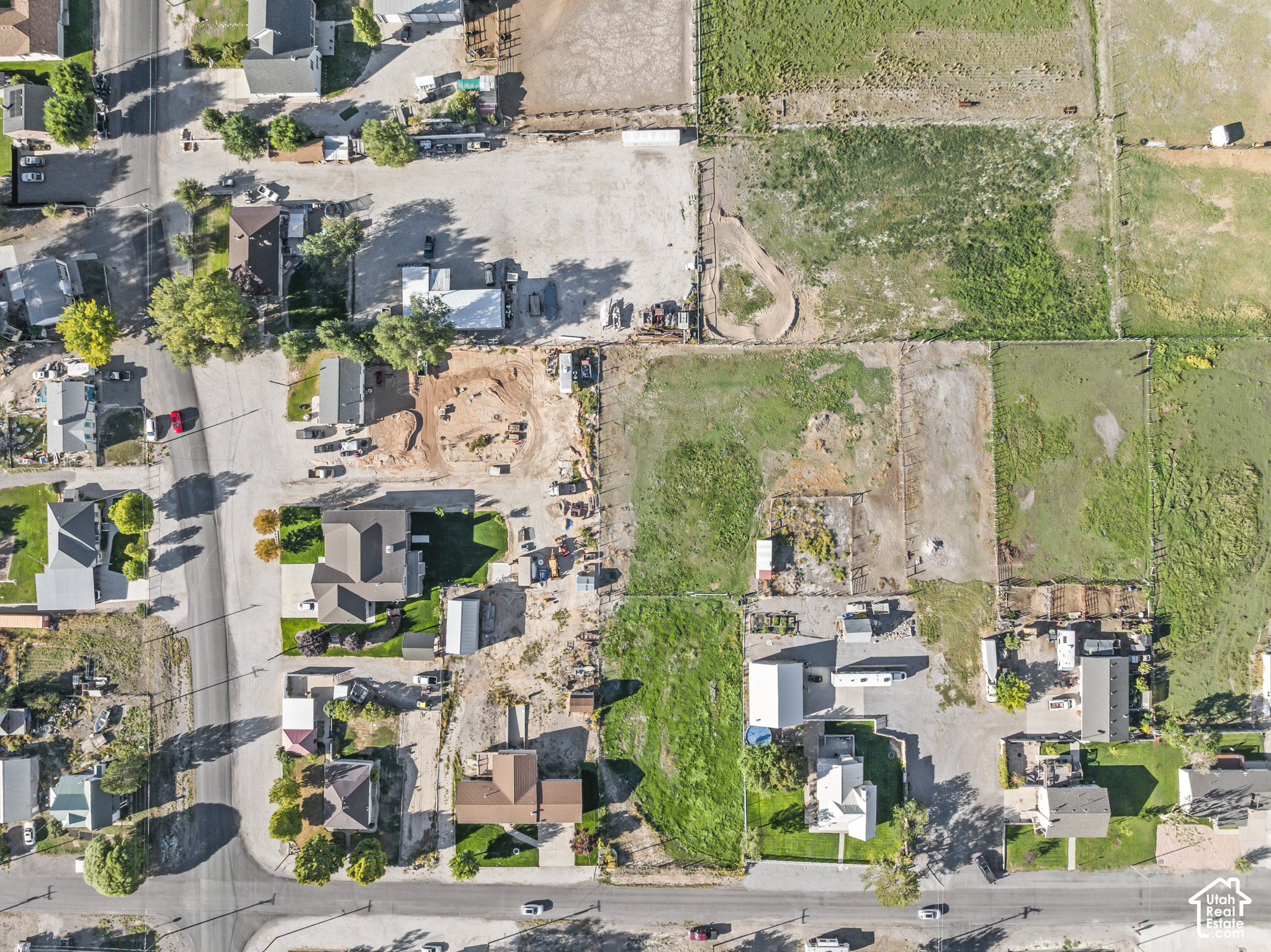 Aerial view of vacant fenced lots among homes and roads in Redmond.