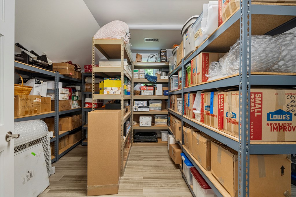Storage room lined with shelves of moving boxes and household supplies.