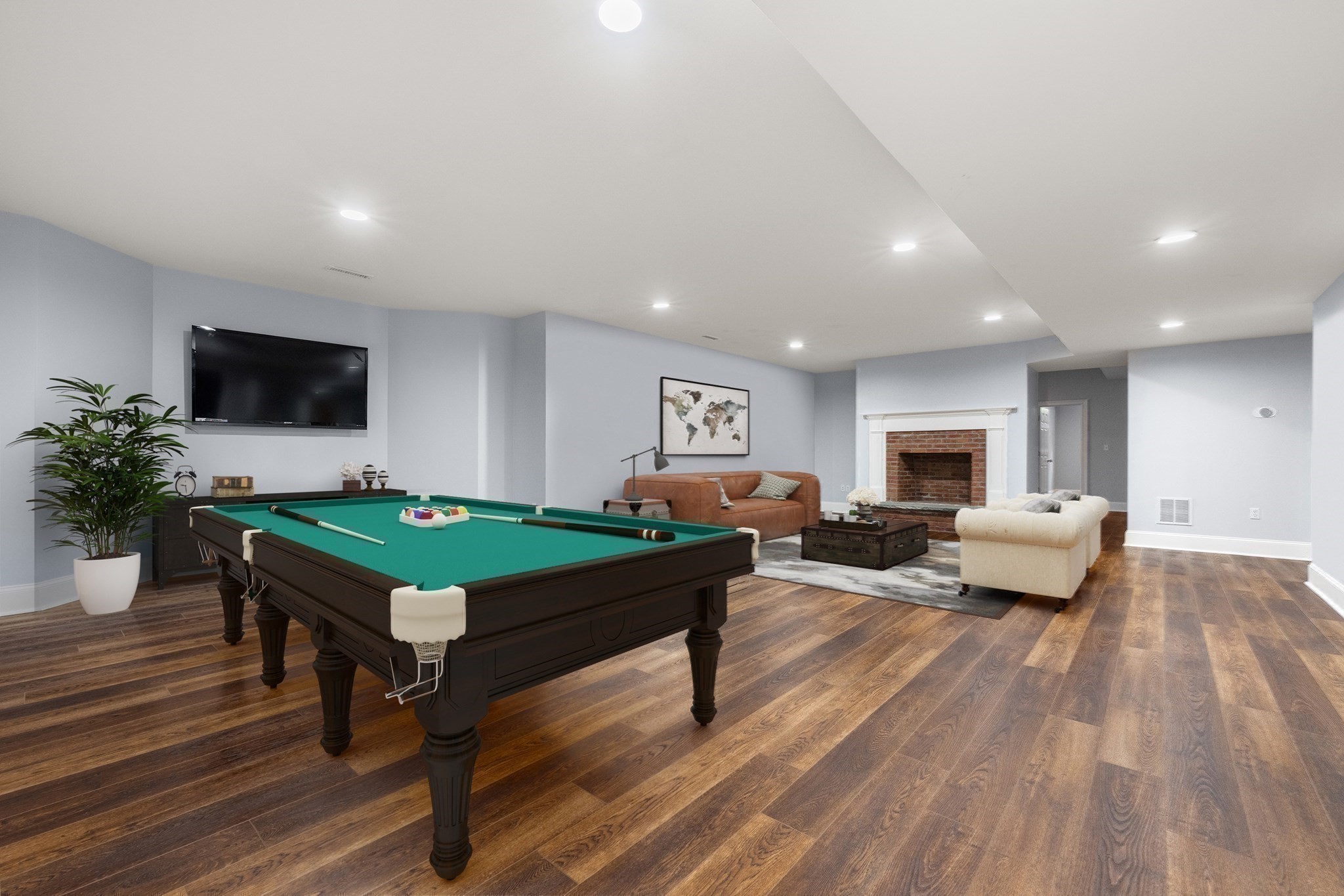 Recreation room with a pool table, fireplace, and comfortable seating area.