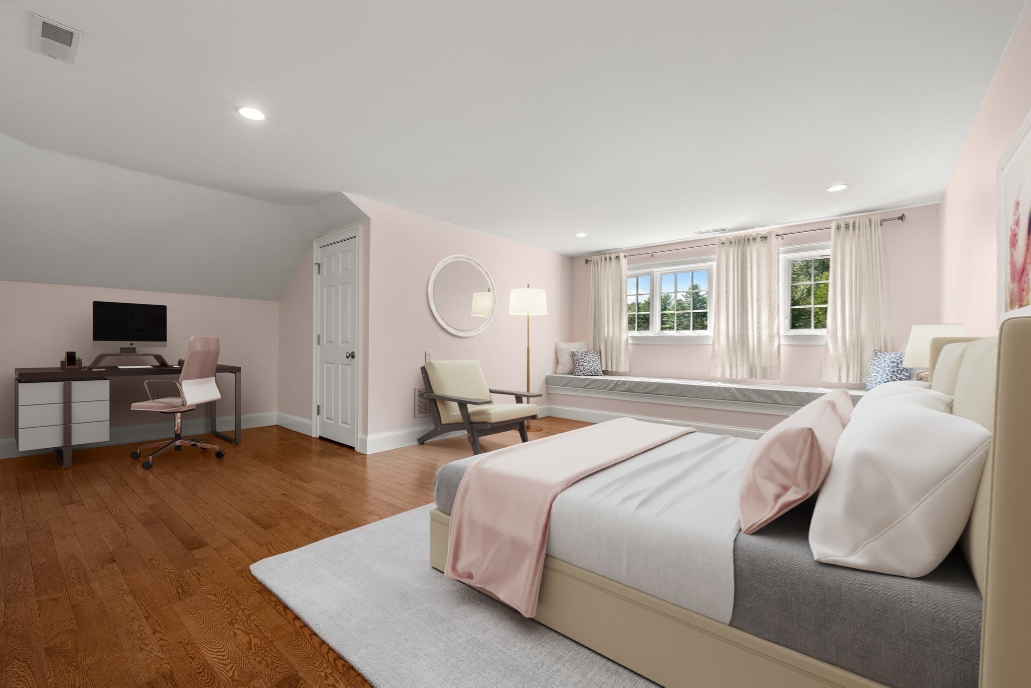 Staged bedroom with a blush-accented bed, hardwood floors, desk, and cushioned window seat.