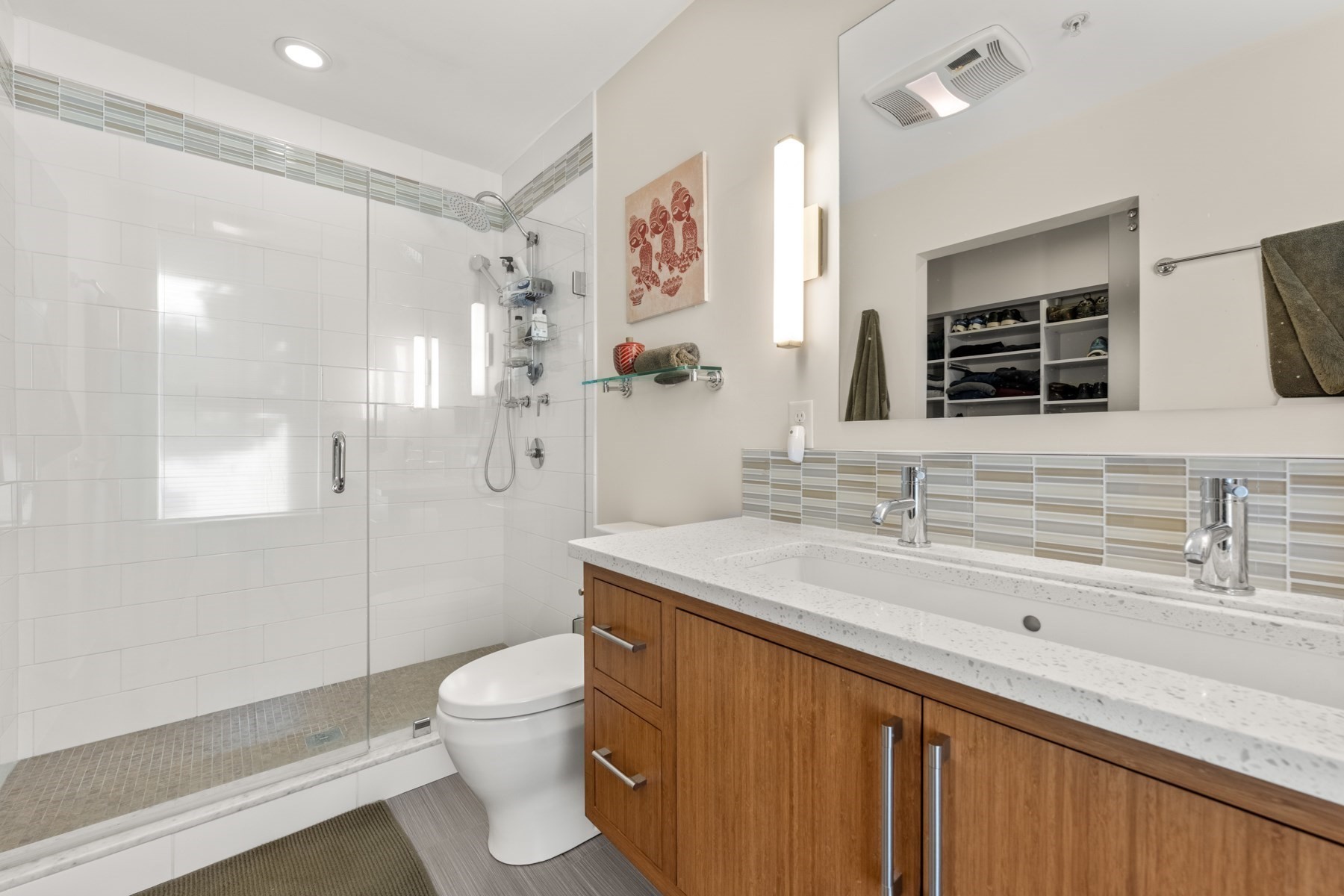 Bathroom with a glass-enclosed shower and double-sink wood vanity.