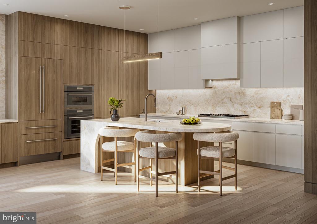 Modern kitchen with wood cabinetry, a large stone island, and three upholstered stools.
