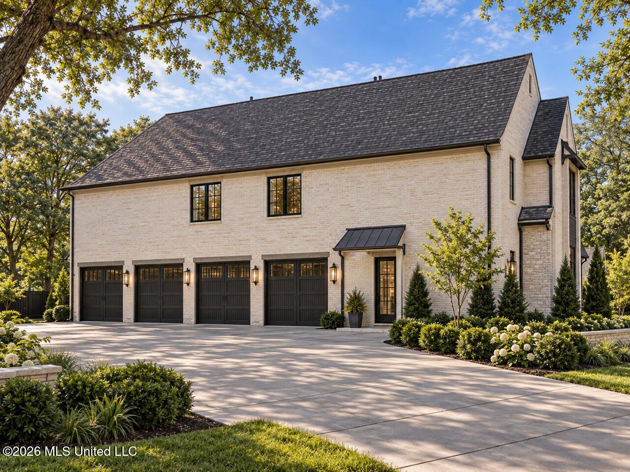 Two-story light brick house with four dark garage doors, a steep roof, and landscaped grounds.