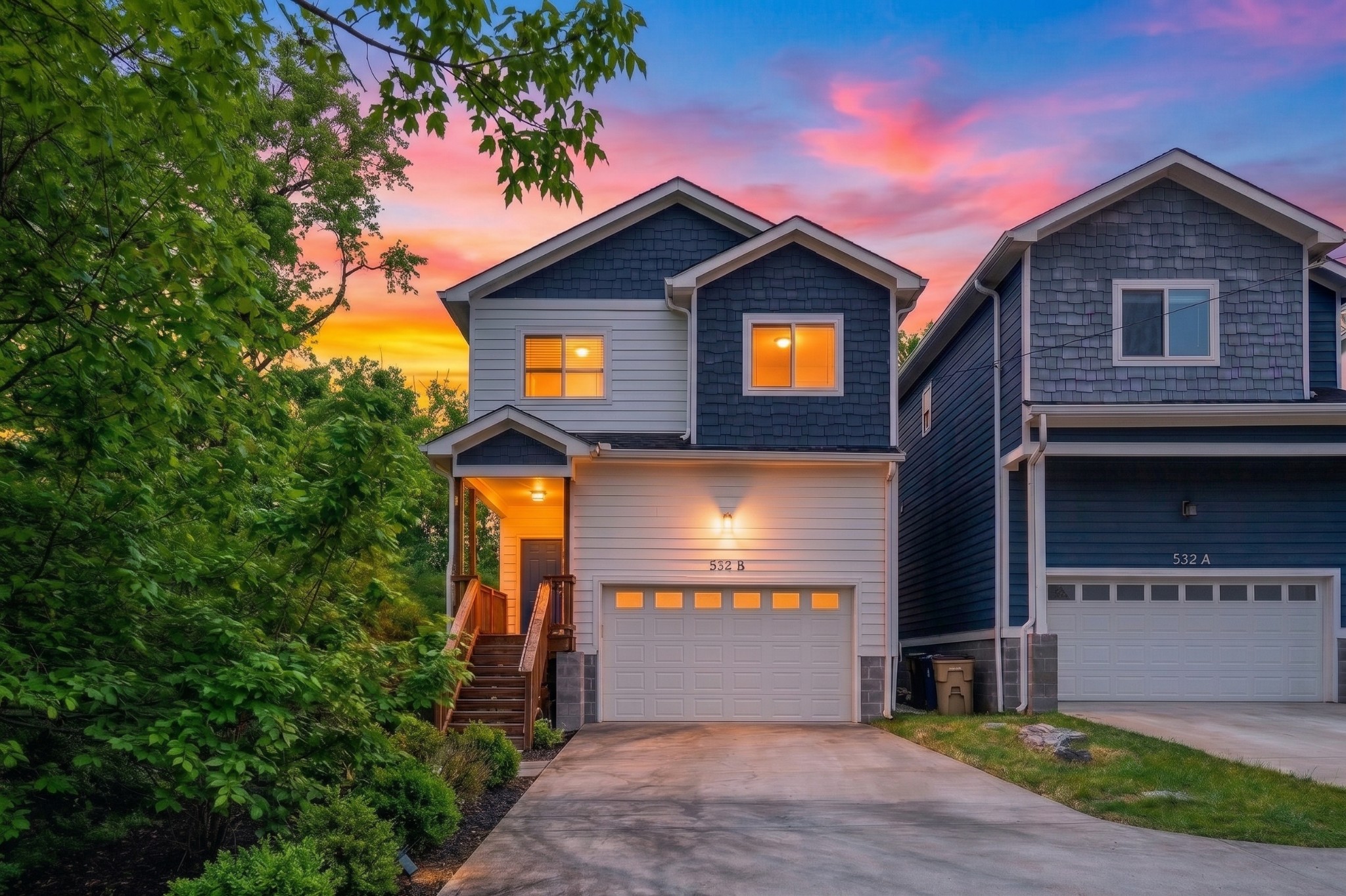 Two-story home marked 532 B beside 532 A, with a front porch and driveway at dusk.