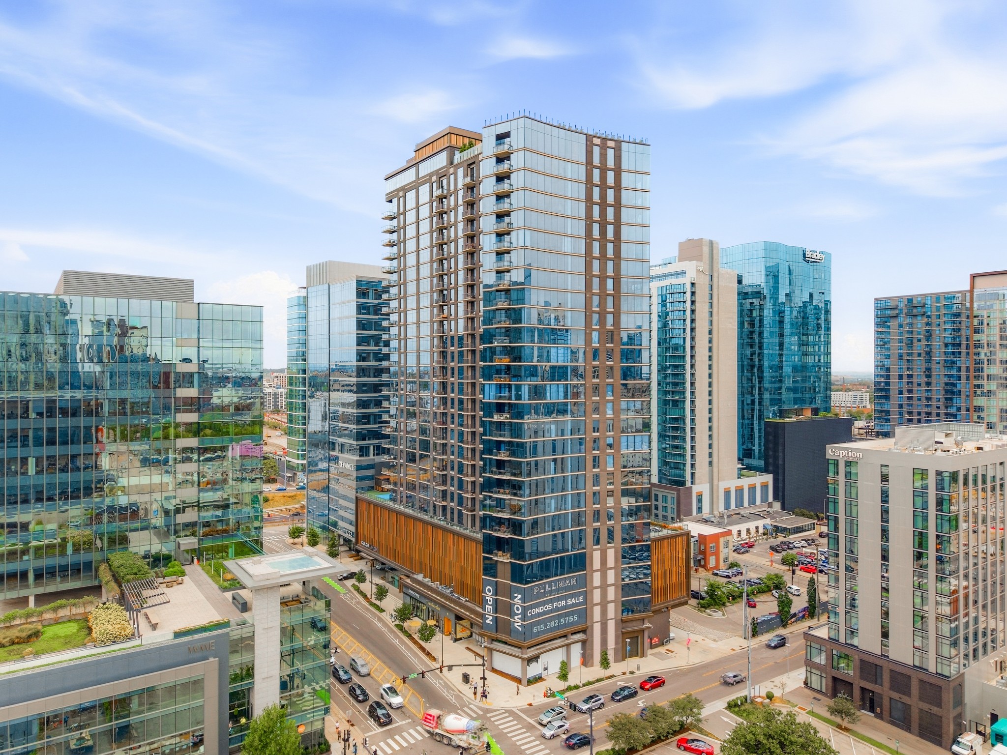 Pullman condominium tower in downtown Nashville, with blue glass windows, balconies, and surrounding high-rises.