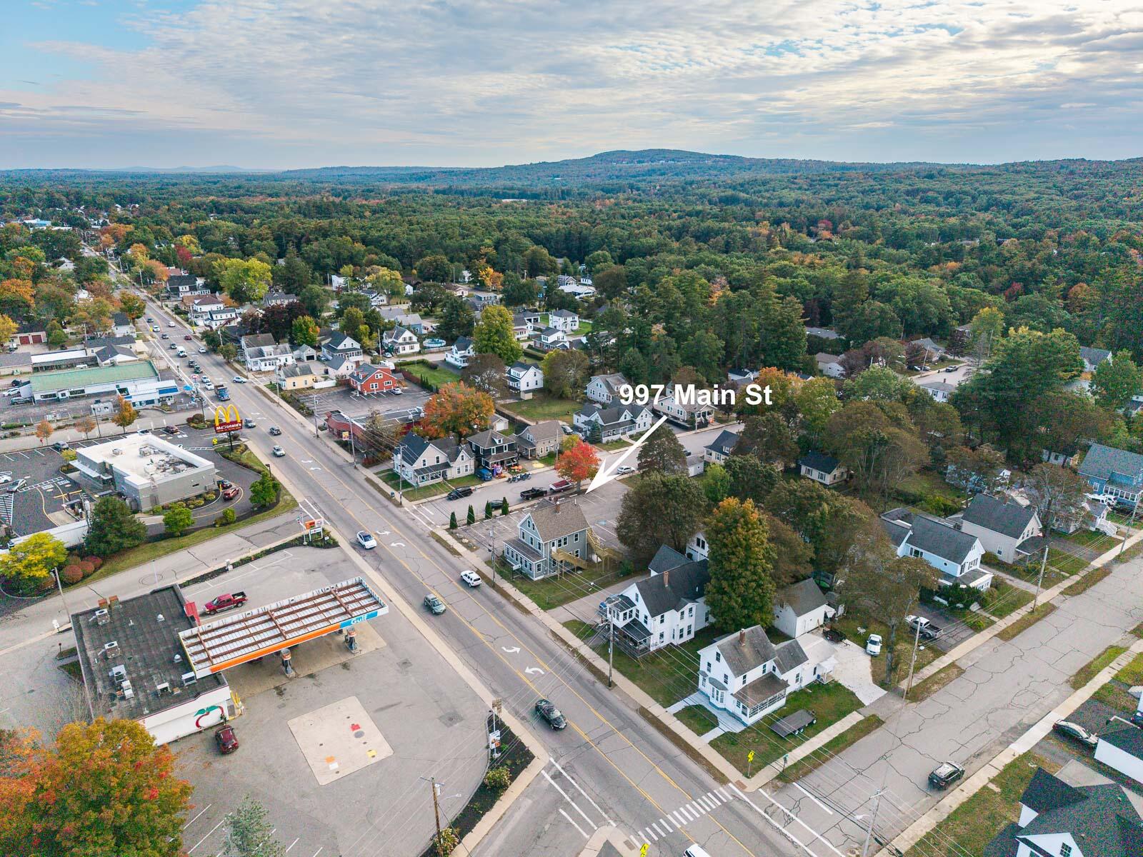 Aerial view of 997 Main Street amid Sanford’s streets and autumn-colored trees.
