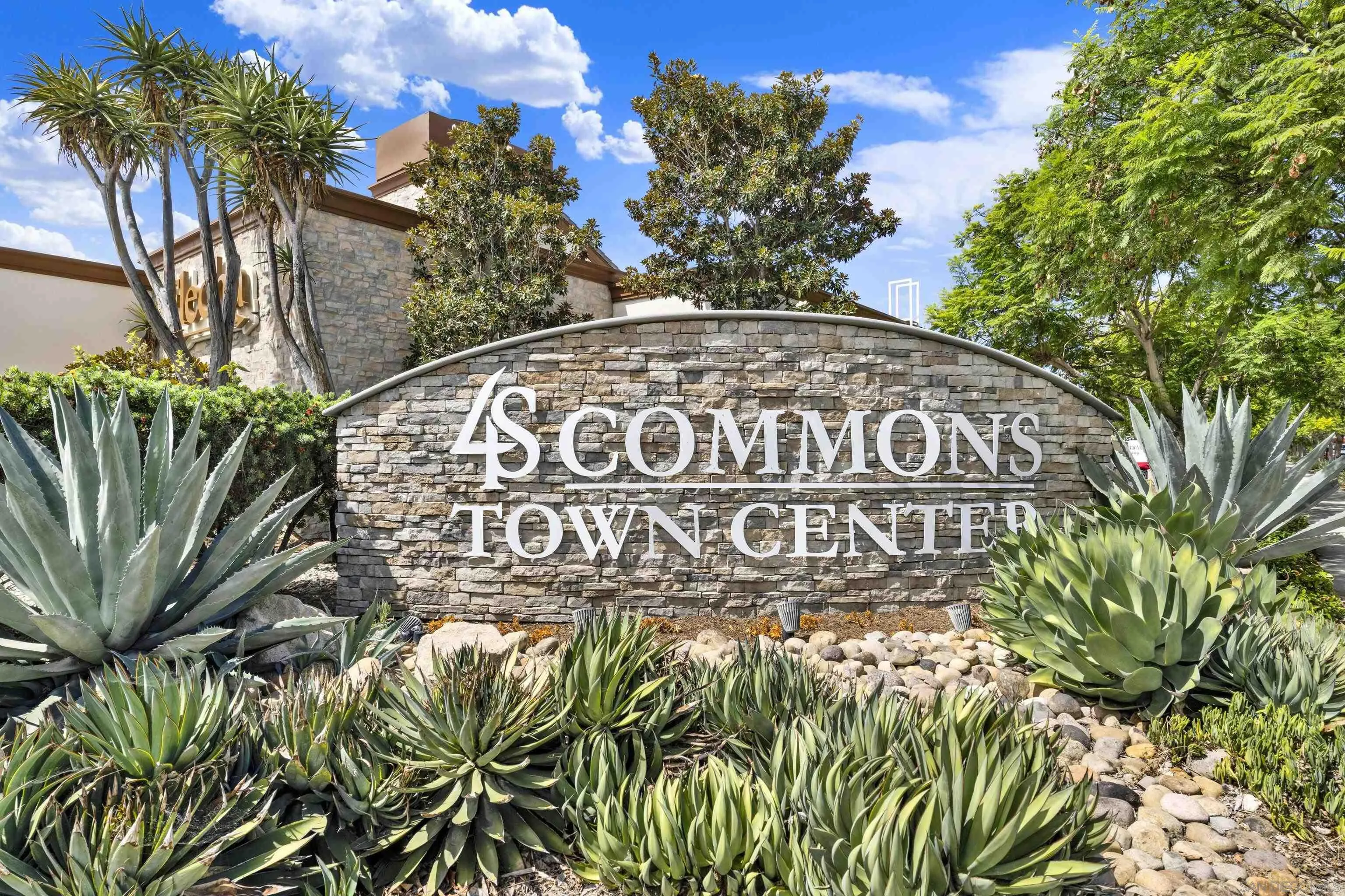 4S Commons Town Center stone entrance sign framed by agave landscaping.
