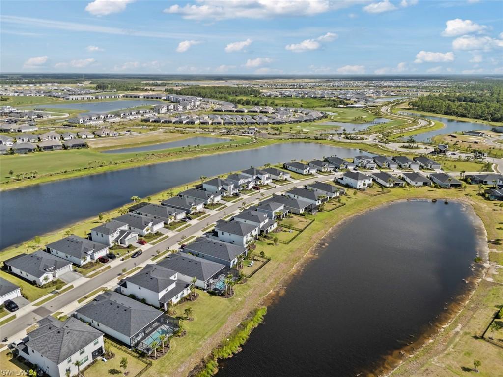 Aerial view of homes along a large lake in a residential community.