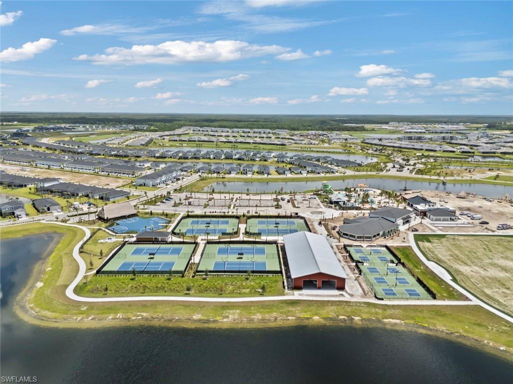 Aerial view of a Punta Gorda community’s tennis courts, pavilion, homes, and surrounding waterways.
