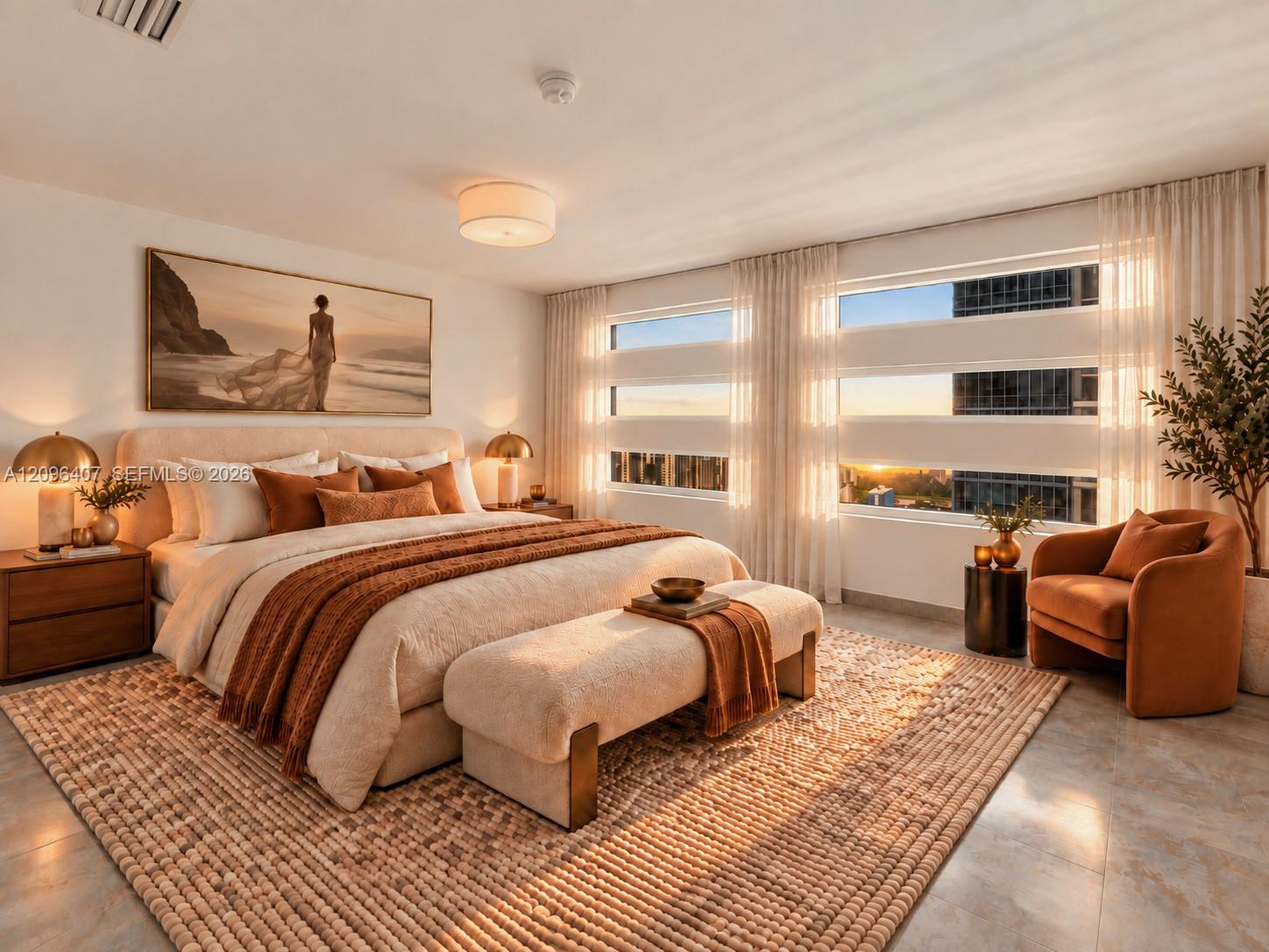 Staged bedroom with an upholstered bed, rust accents, and tall windows glowing in golden-hour light.