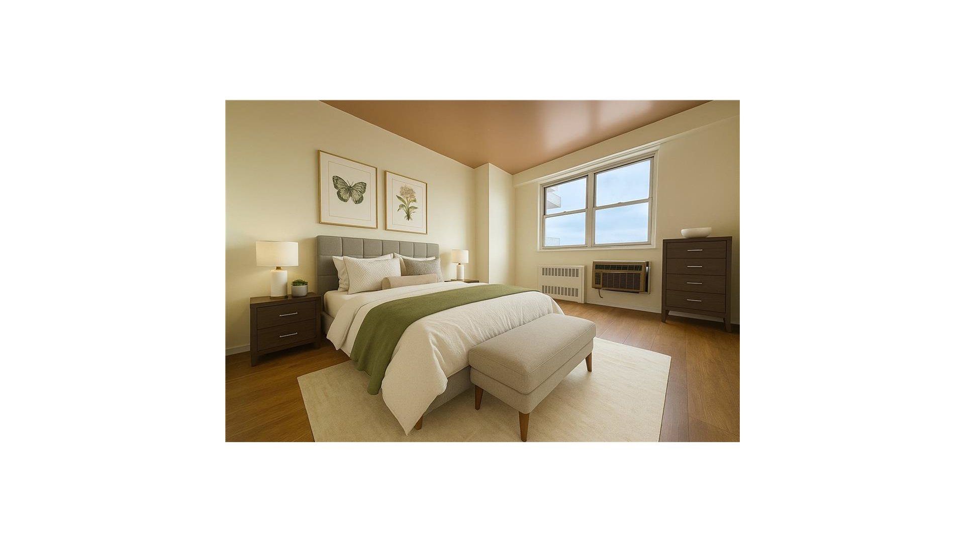 Bedroom with a neatly made bed, cushioned bench, and large window.