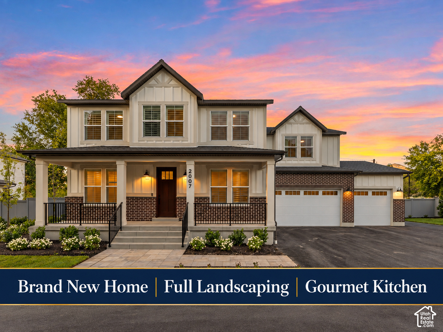 Two-story white and brick home with a covered porch and double garage at sunset.