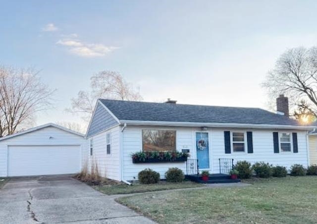 White single-story house with blue shutters and front door, attached garage, and driveway.