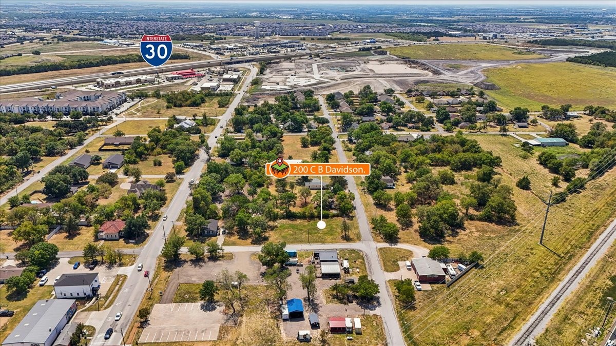 Aerial view of the 200 C B Davidson property, marked near Interstate 30 among homes and open land.
