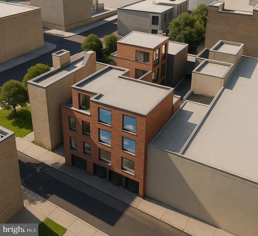 Aerial view of modern red-brick townhouses among closely spaced flat-roofed buildings.