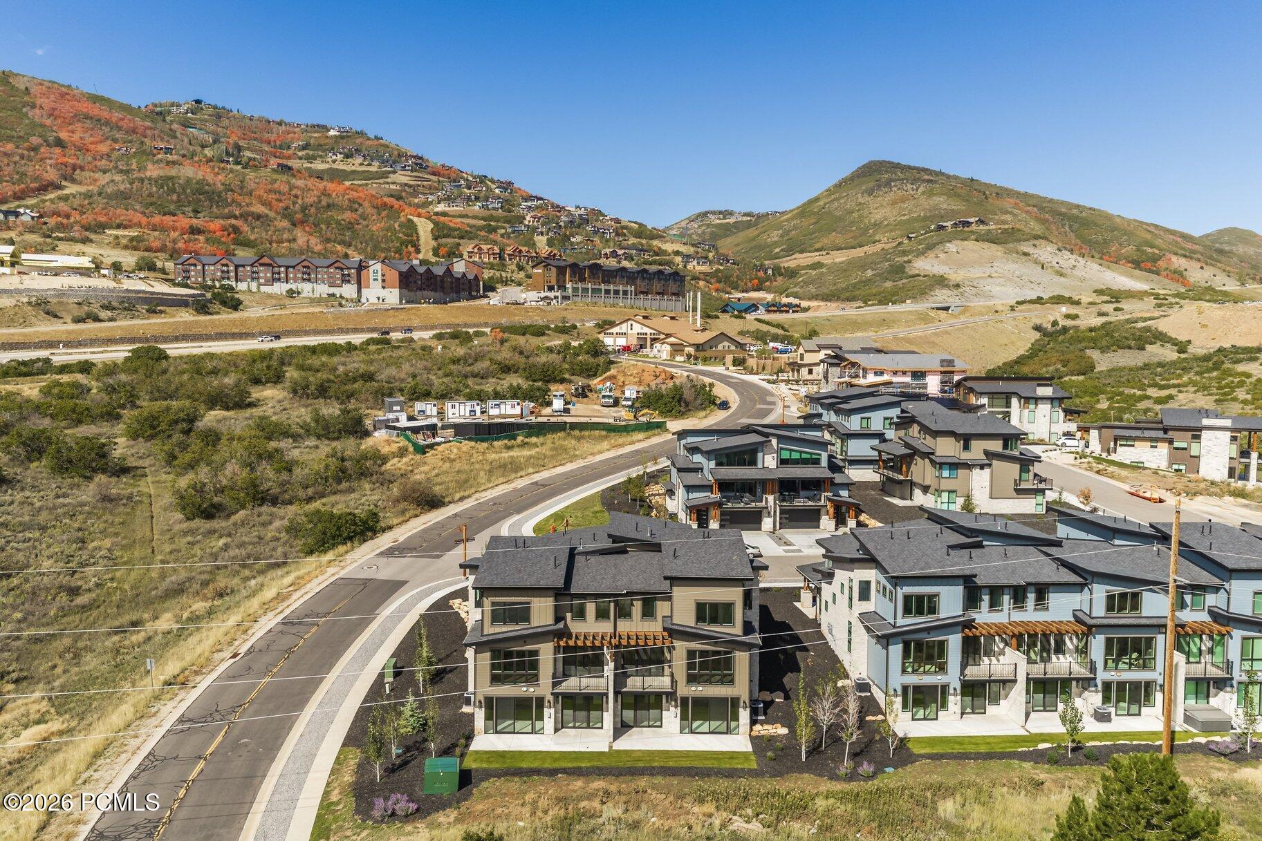 Aerial view of modern homes in a mountain community, with autumn hillsides in the background.