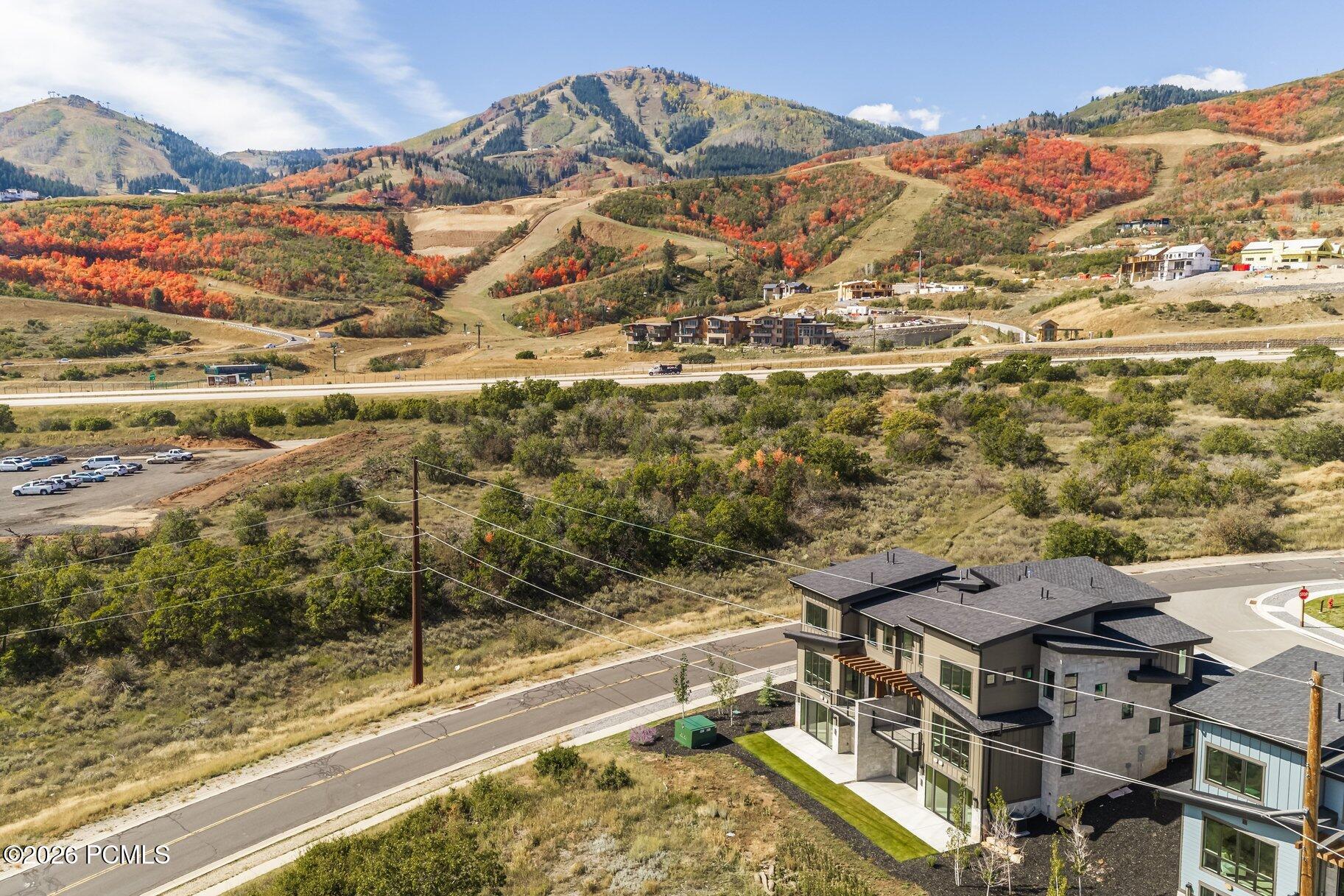 Modern home overlooking an autumn mountain valley and hillside development.