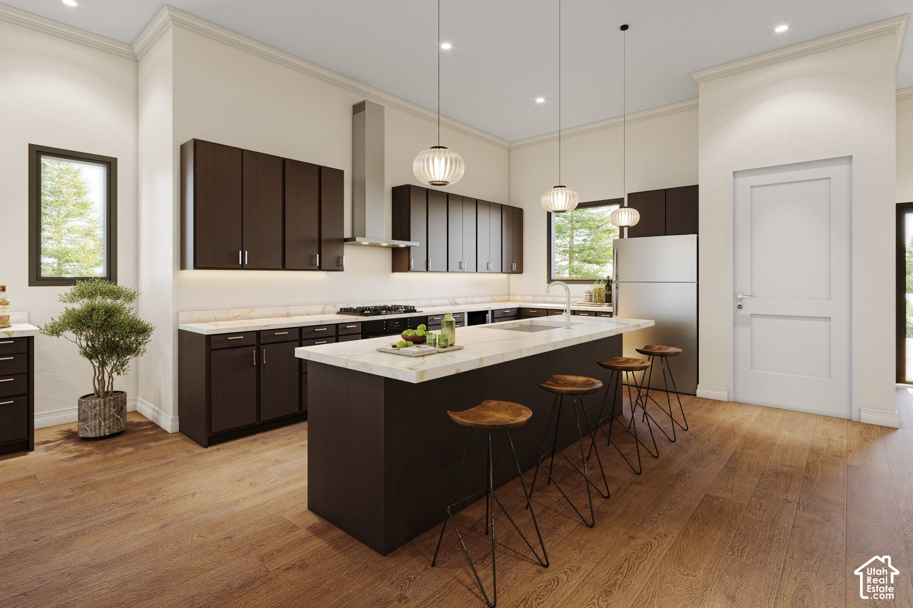 Kitchen with dark wood cabinets, a large stone island, and pendant lights.