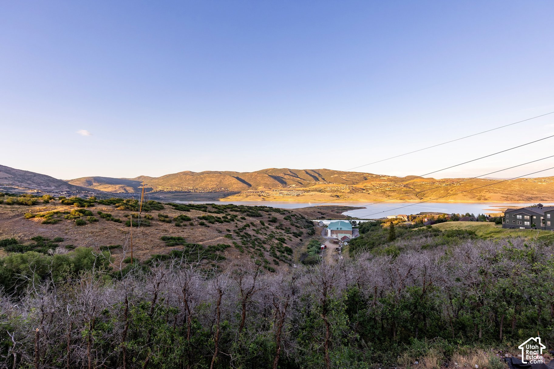 Vacant hillside lot overlooking a reservoir and surrounding mountain ridges.