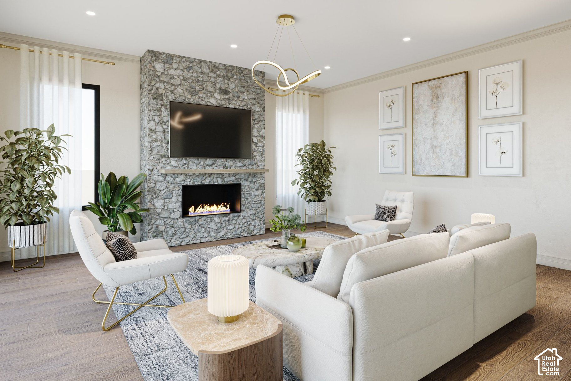 Living room with a stone fireplace, mounted television, white seating, and sculptural gold chandelier.