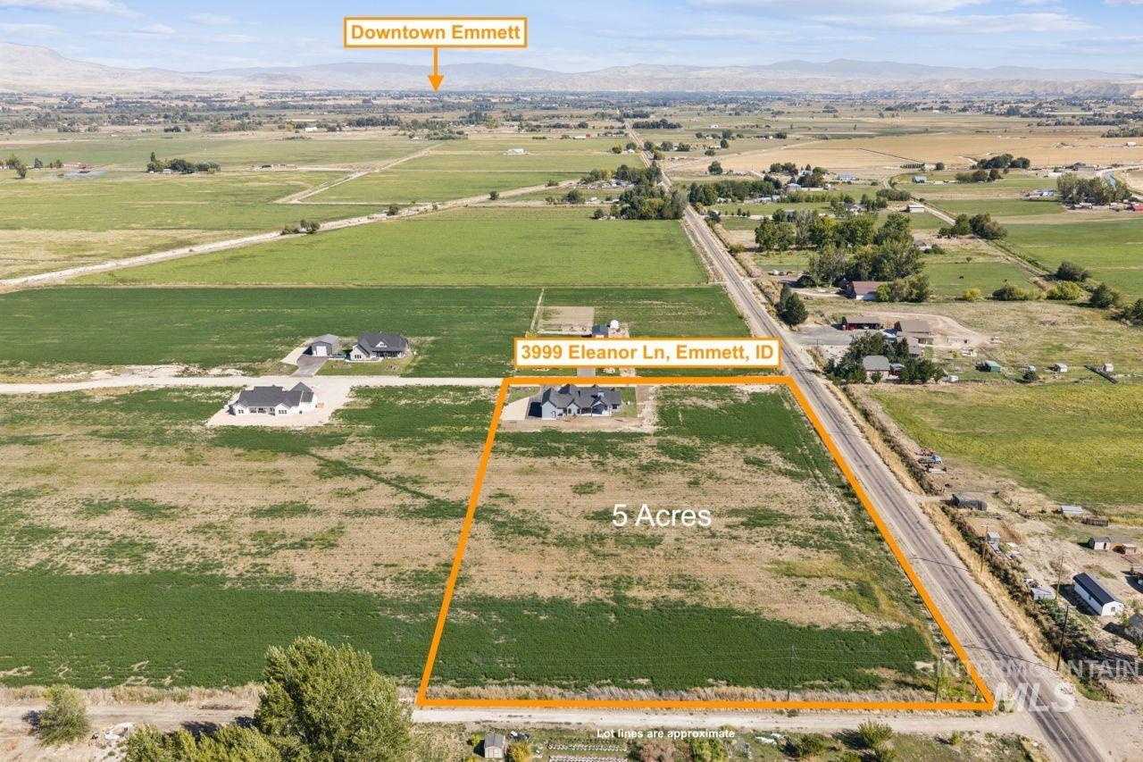 Aerial view of a five-acre property near Emmett, with a house, surrounding fields, and distant mountains.