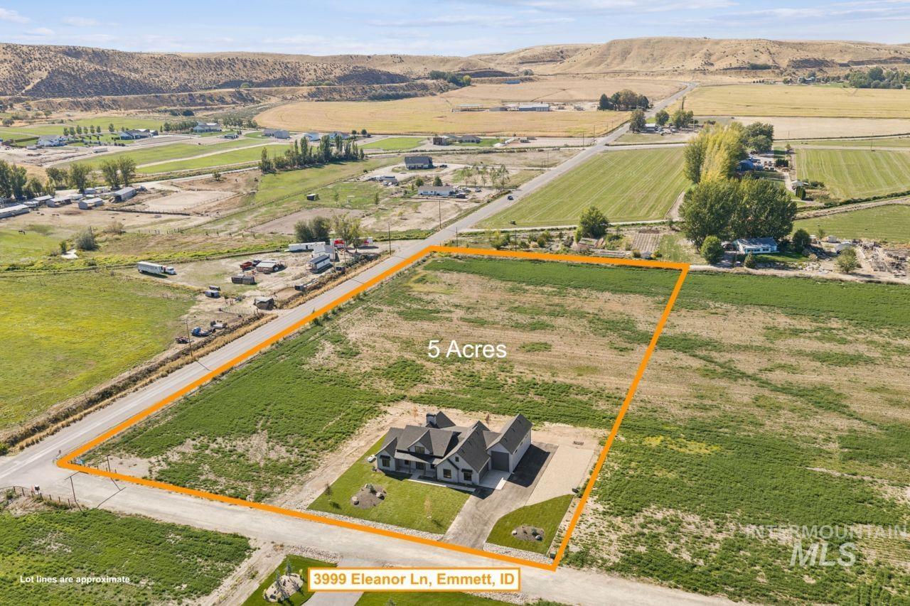 Aerial view of a five-acre parcel with a house, outlined lot lines, and surrounding farmland.