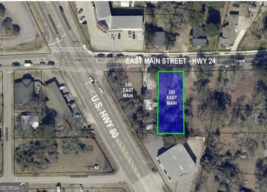 Aerial view of the outlined 320 East Main parcel at the intersection of East Main Street and U.S. Highway 80.