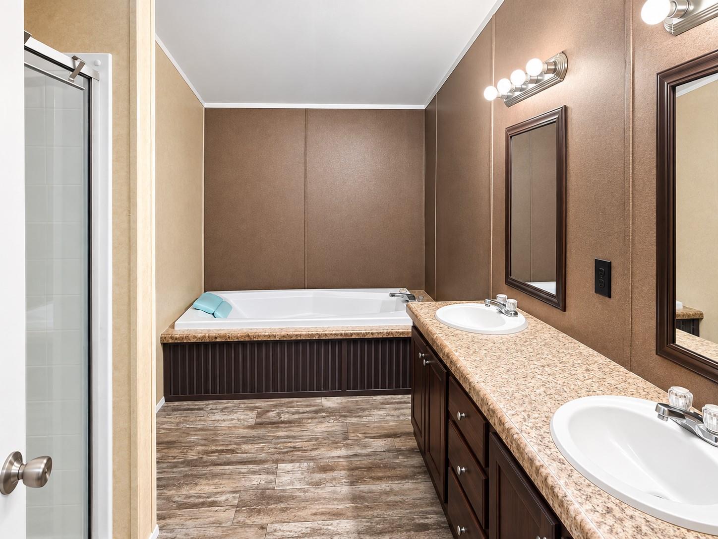 Bathroom with a soaking tub, double-sink vanity, and brown cabinetry.