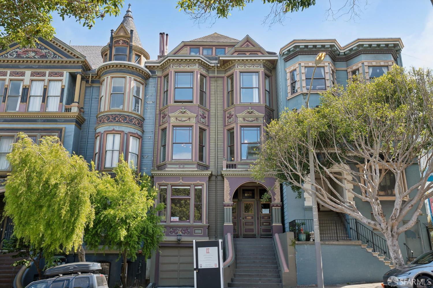 Ornate San Francisco Victorian house with a turret, decorative facade, and broad front staircase.