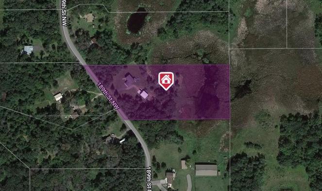 Aerial view of a wooded rural property outlined in purple beside 189th Street NW.