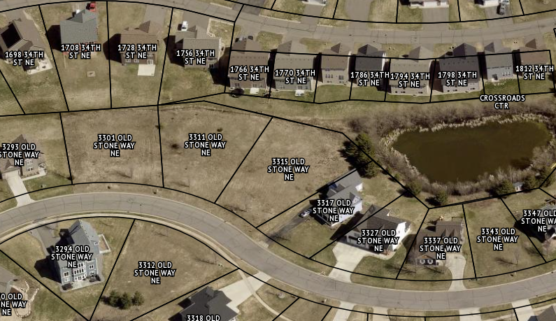 Aerial parcel map of 3315 Old Stone Way, with outlined lots, neighboring homes, a curved road, and a pond.
