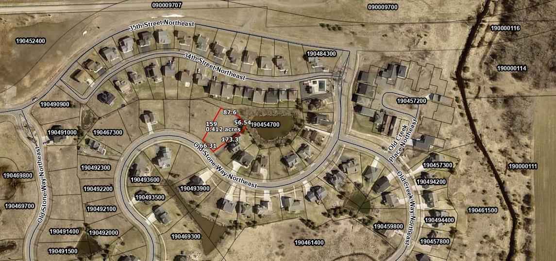 Aerial view of a residential neighborhood with parcel boundaries and lot measurements along Old Stone Way Northeast.