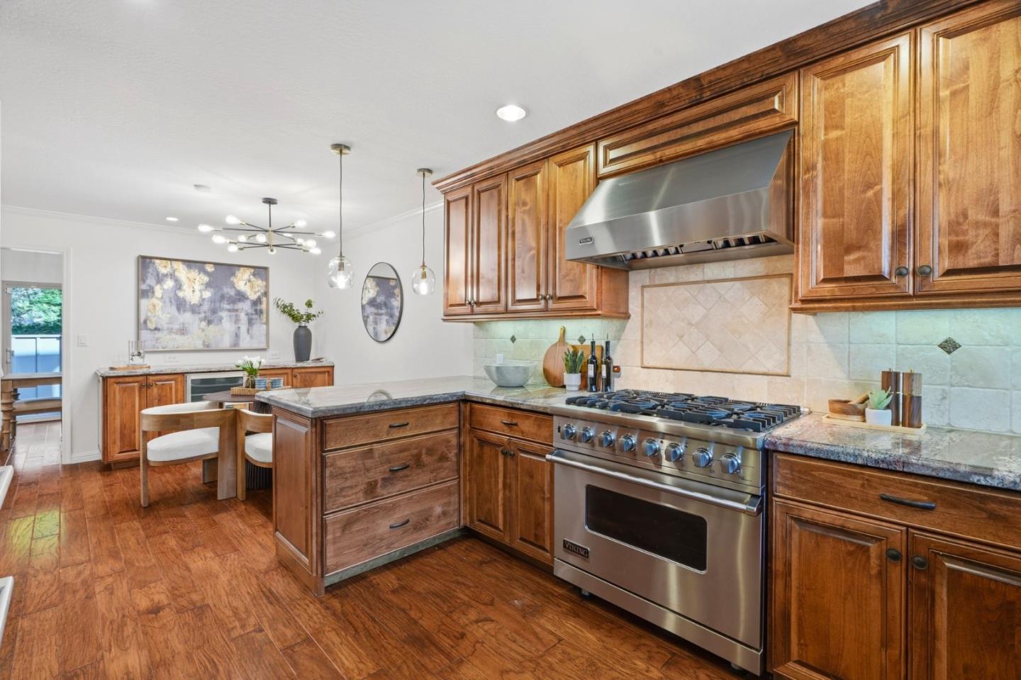 Kitchen with warm wood cabinetry, a large island, and a stainless-steel Viking range.