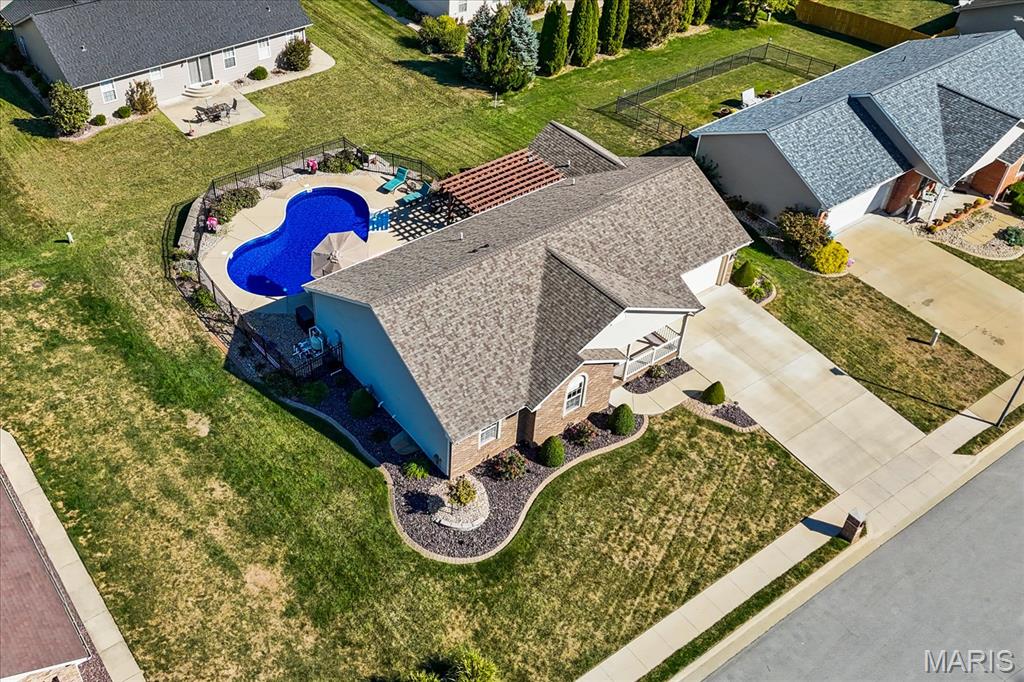 Single-story home on a corner lot with a fenced backyard pool and patio.