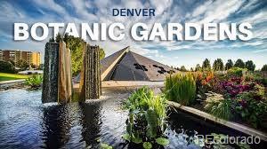 Denver Botanic Gardens with water, tall grasses, flower beds, and a pyramid-shaped glass structure.