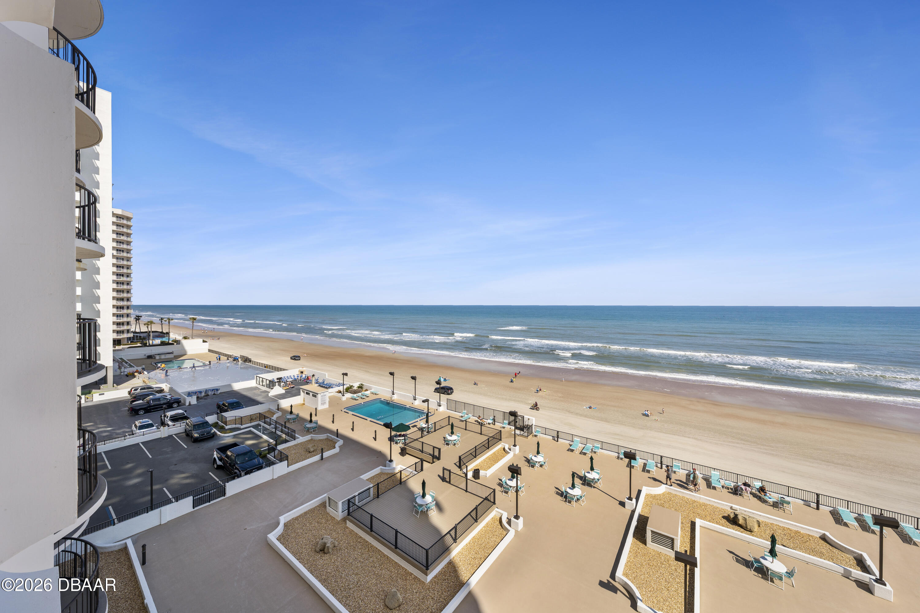 Oceanfront condominium pool deck overlooking the beach and Atlantic Ocean.