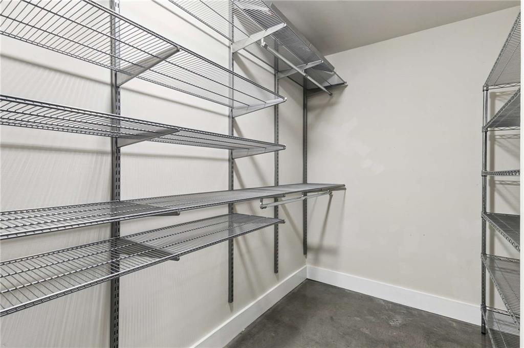Walk-in storage closet with extensive wire shelving and a hanging rod.