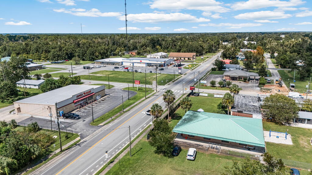 Aerial view of a commercial intersection with a Family Dollar store and low-rise buildings.