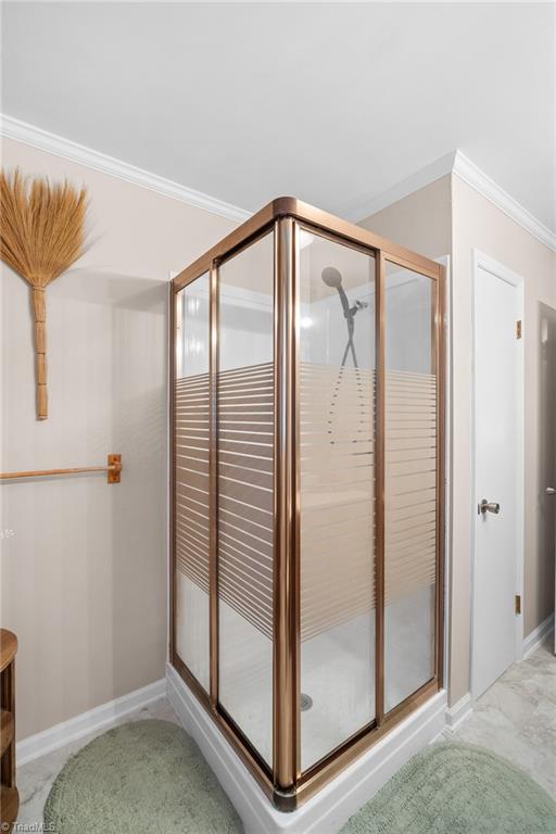 Corner glass shower with bronze-colored frame and striped privacy panels.