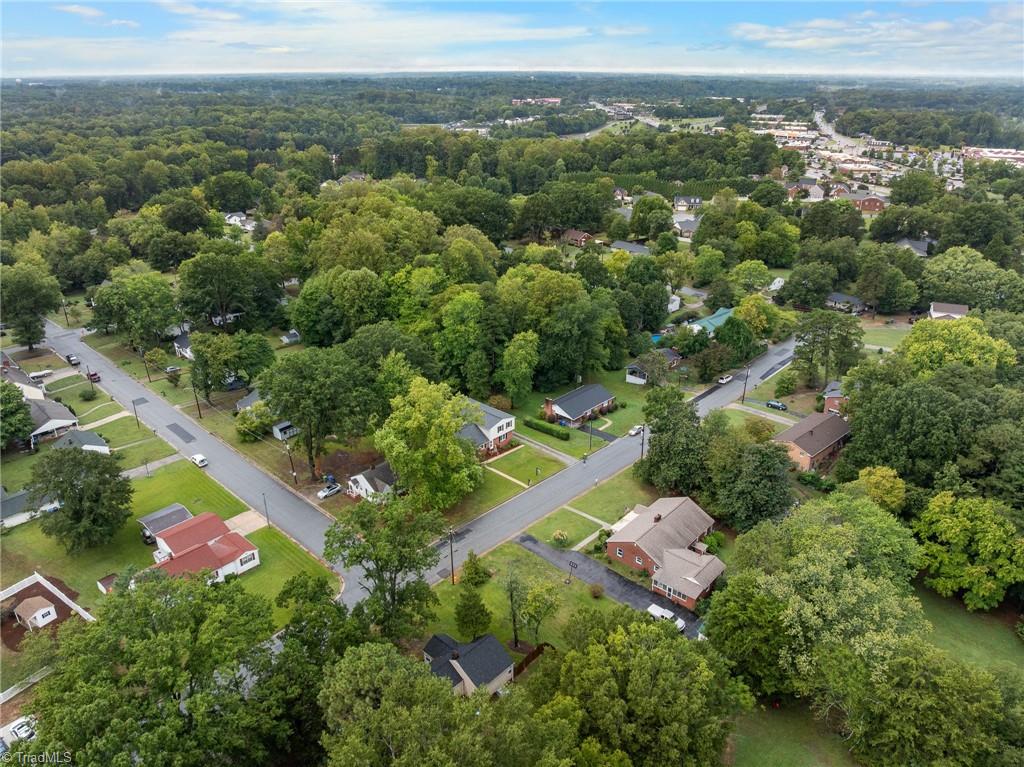 Aerial view of a leafy Kernersville neighborhood with homes and tree-lined streets.
