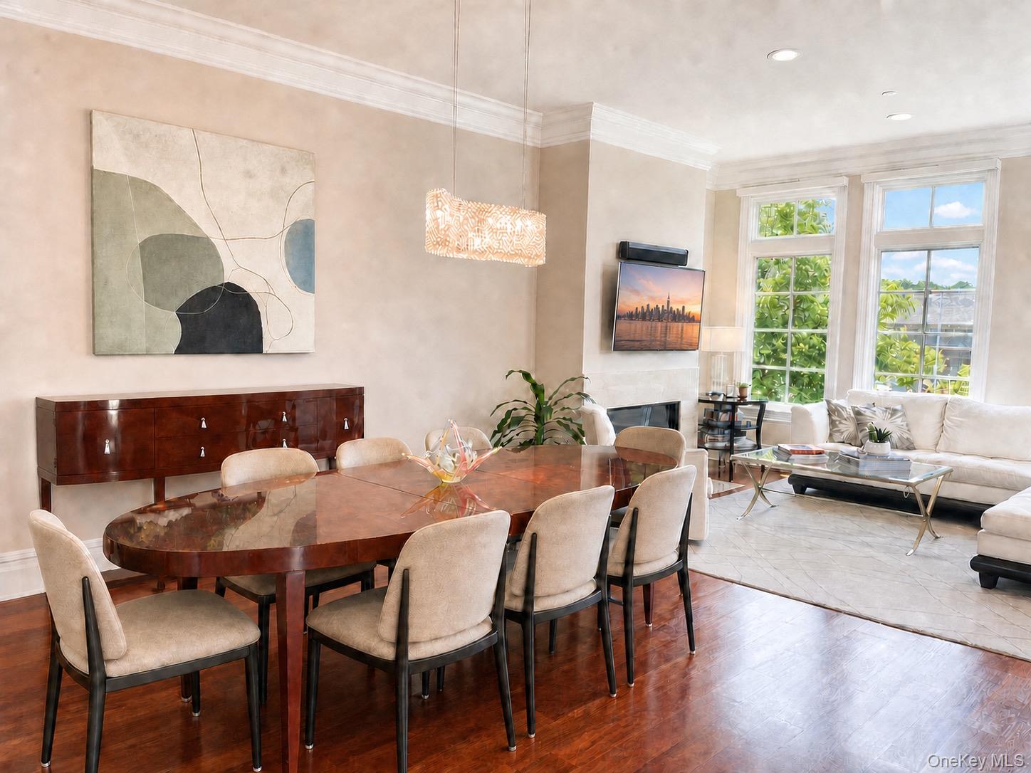 Dining and living area with a glossy wood table, cream seating, hardwood floors, and tall windows.