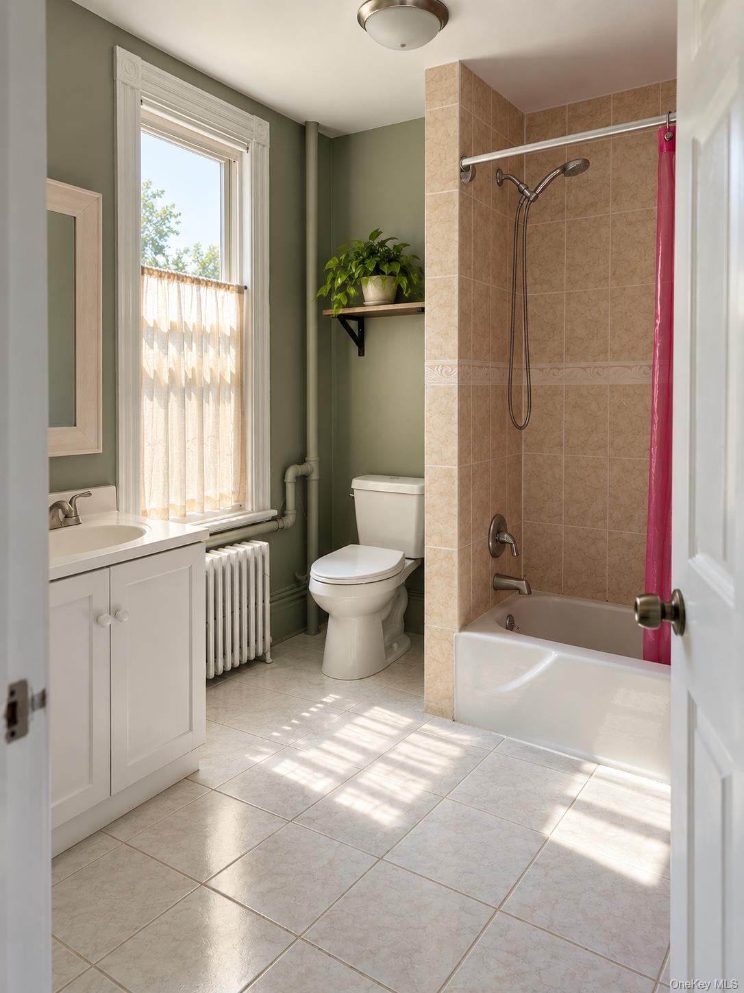 Bathroom with a beige tiled tub and shower, white vanity, and sunlit window beside olive-green walls.